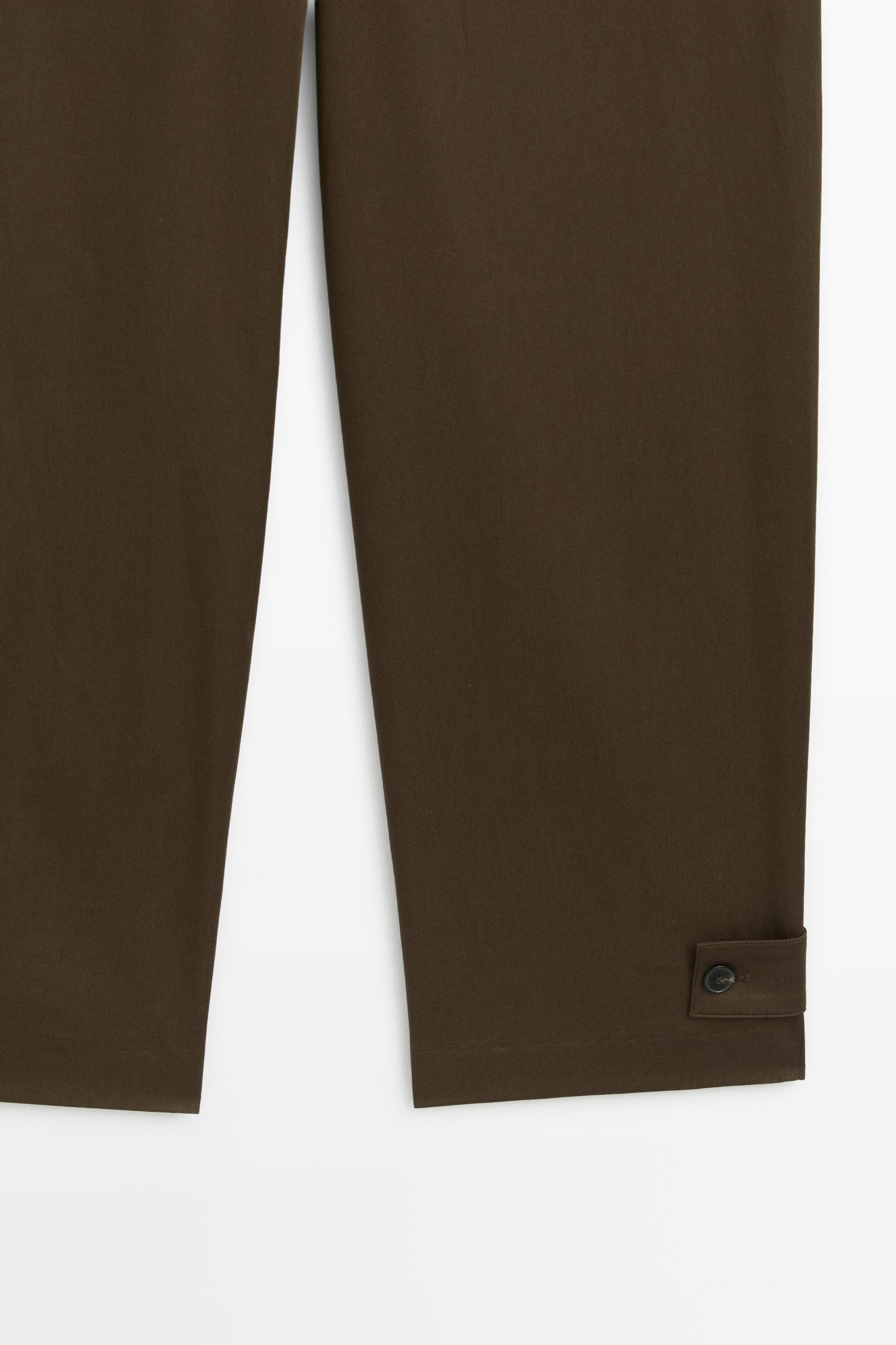 Pants with buttoned hem detail